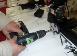 A reversible, battery powered electric drill  makes quick work of long travels in either direction. An electric screwdriver would work too.